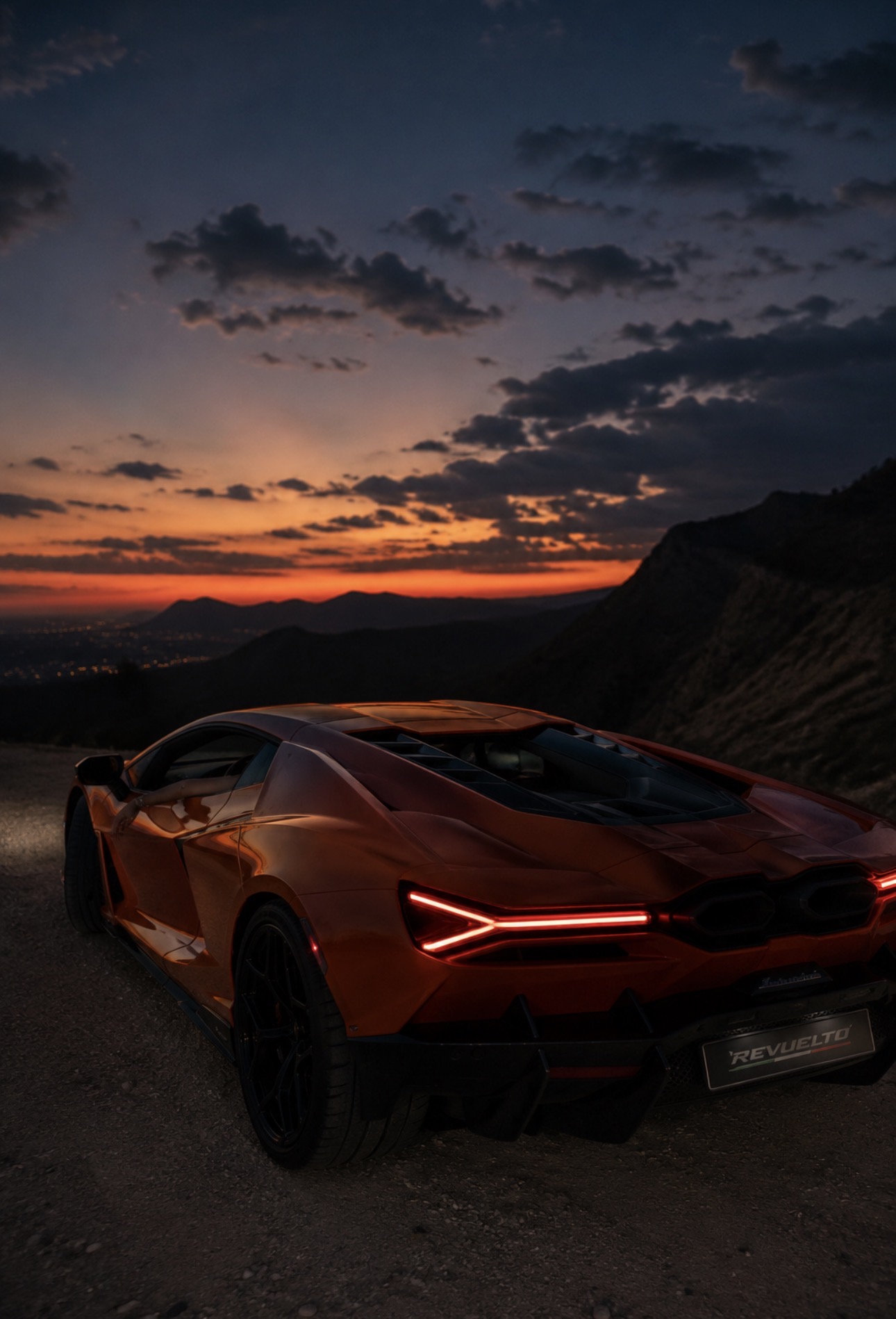 Orange sports car at sunset