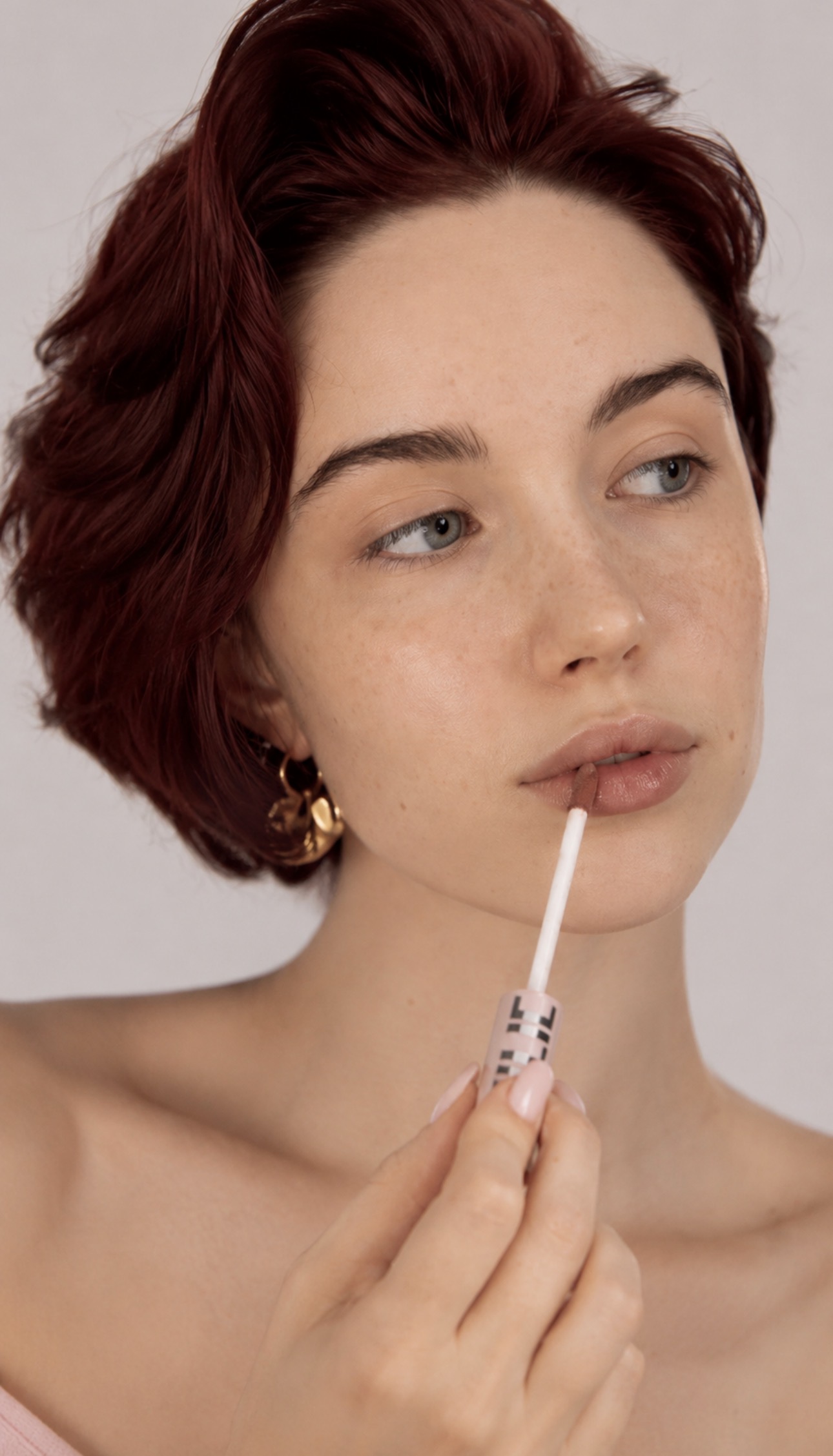 Alice Kwong applying lip product in a beauty close-up