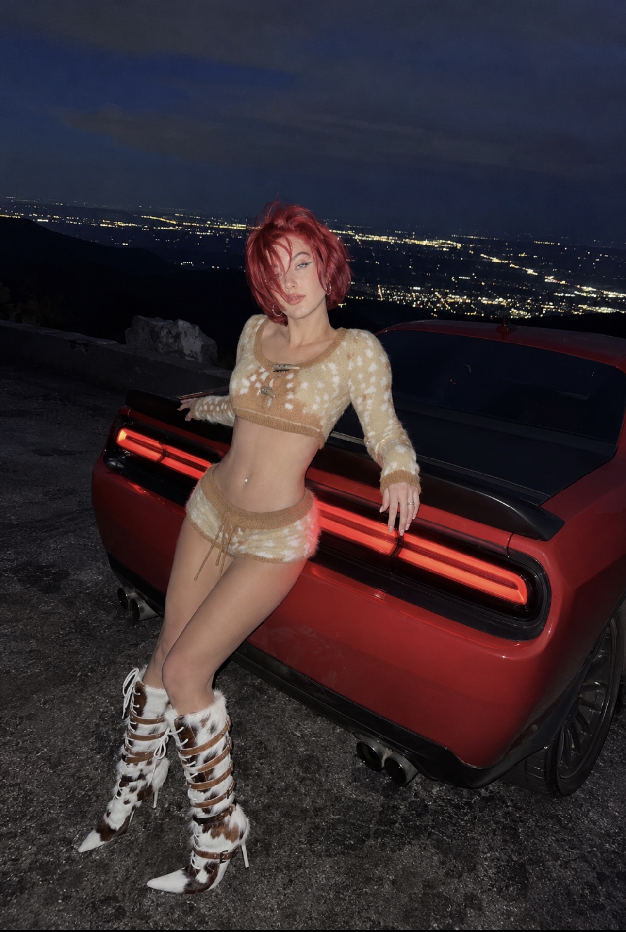 Alice Kwong beside a red sports car at night