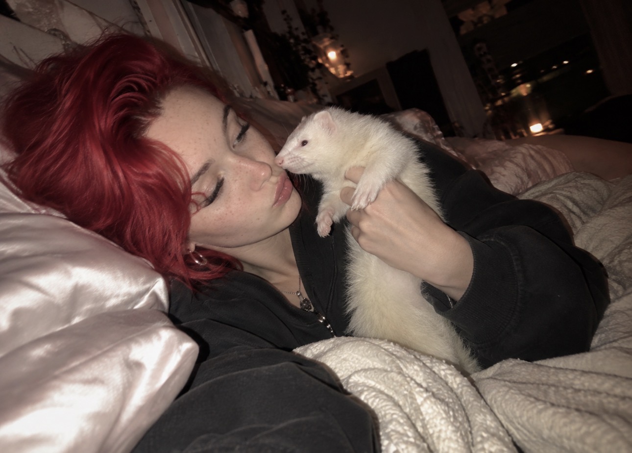 Alice Kwong sharing a candid moment with her white ferret