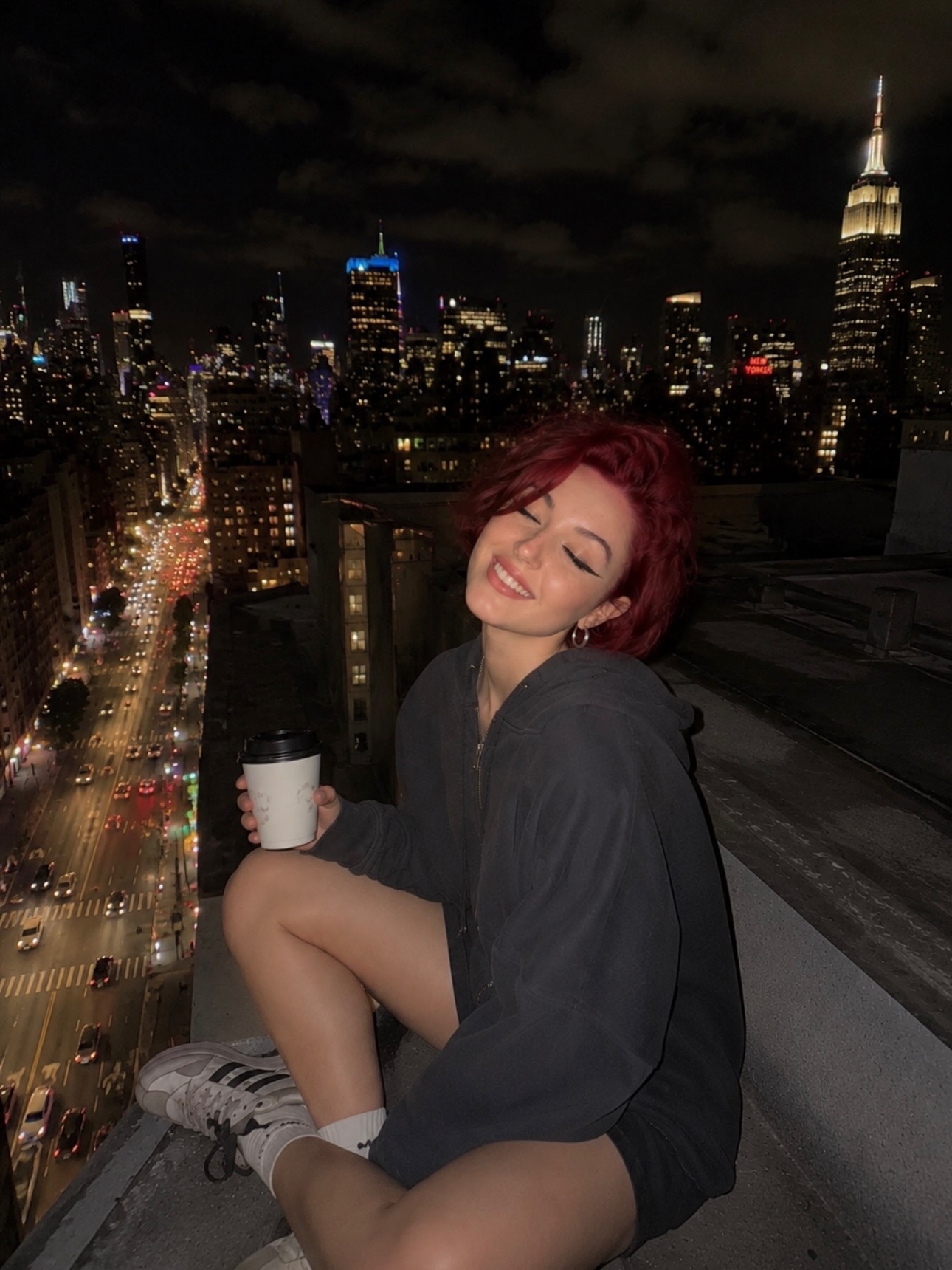 Alice Kwong on a city rooftop at night